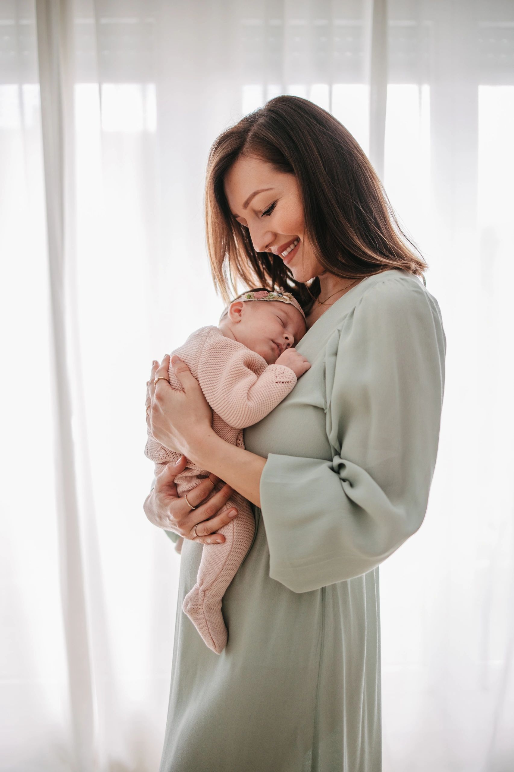 Mother holding her newborn baby peacefully