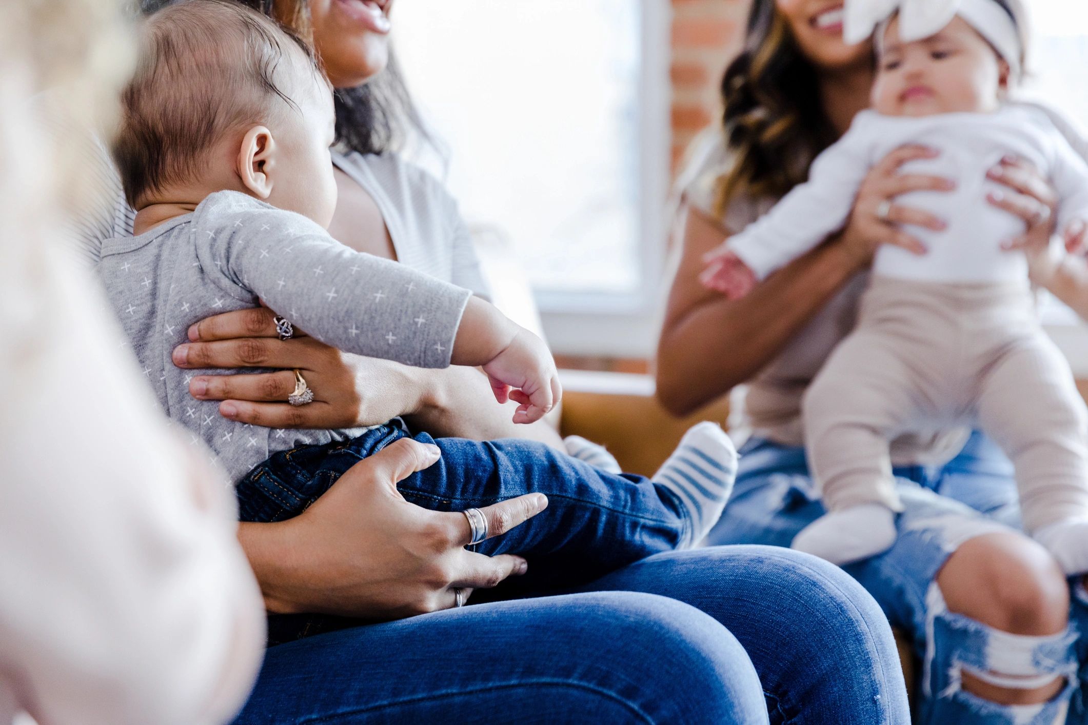 Adults sitting together with young children in conversation