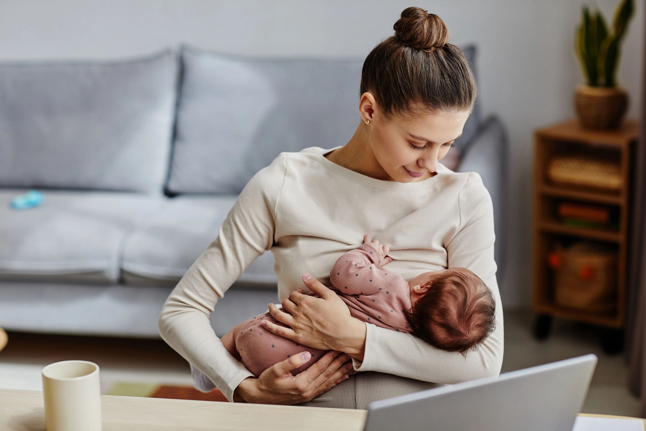 Mother holding baby during a lactation consultation