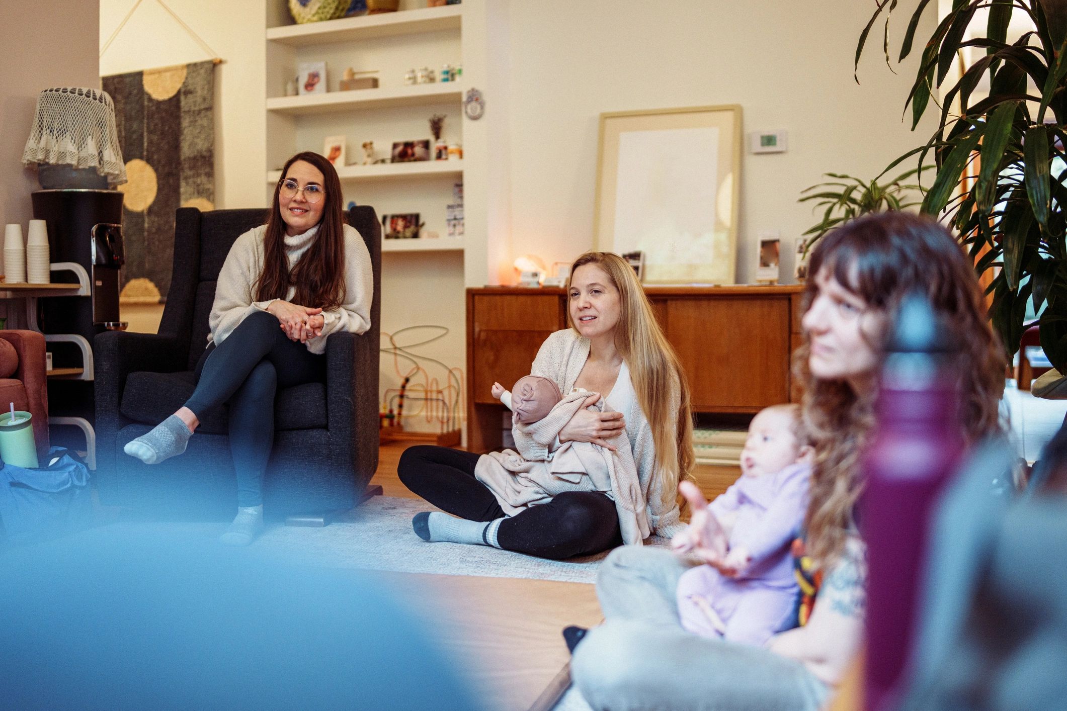 New parents attending a supportive group with their babies