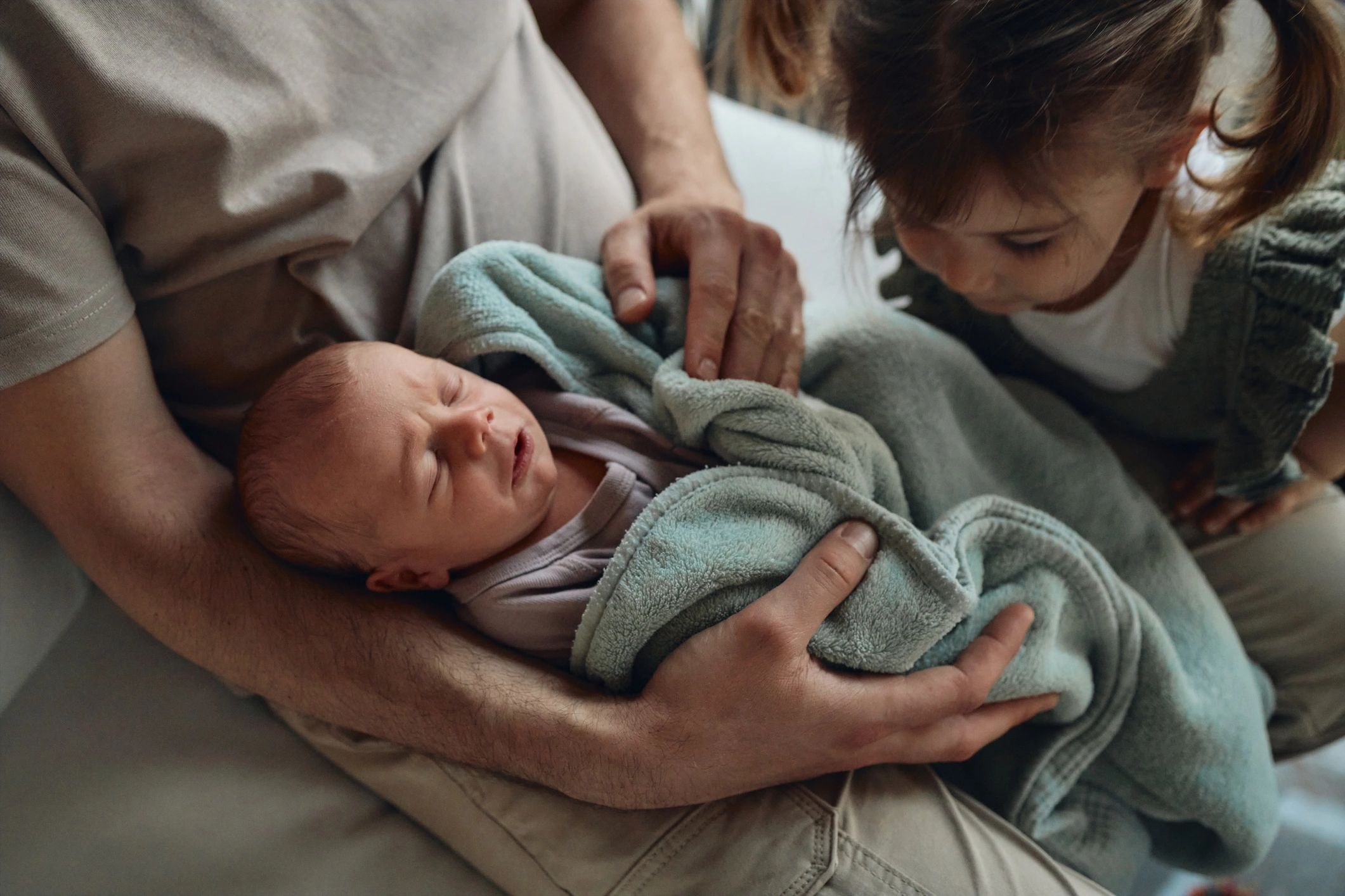 Family welcoming and caring for a newborn baby