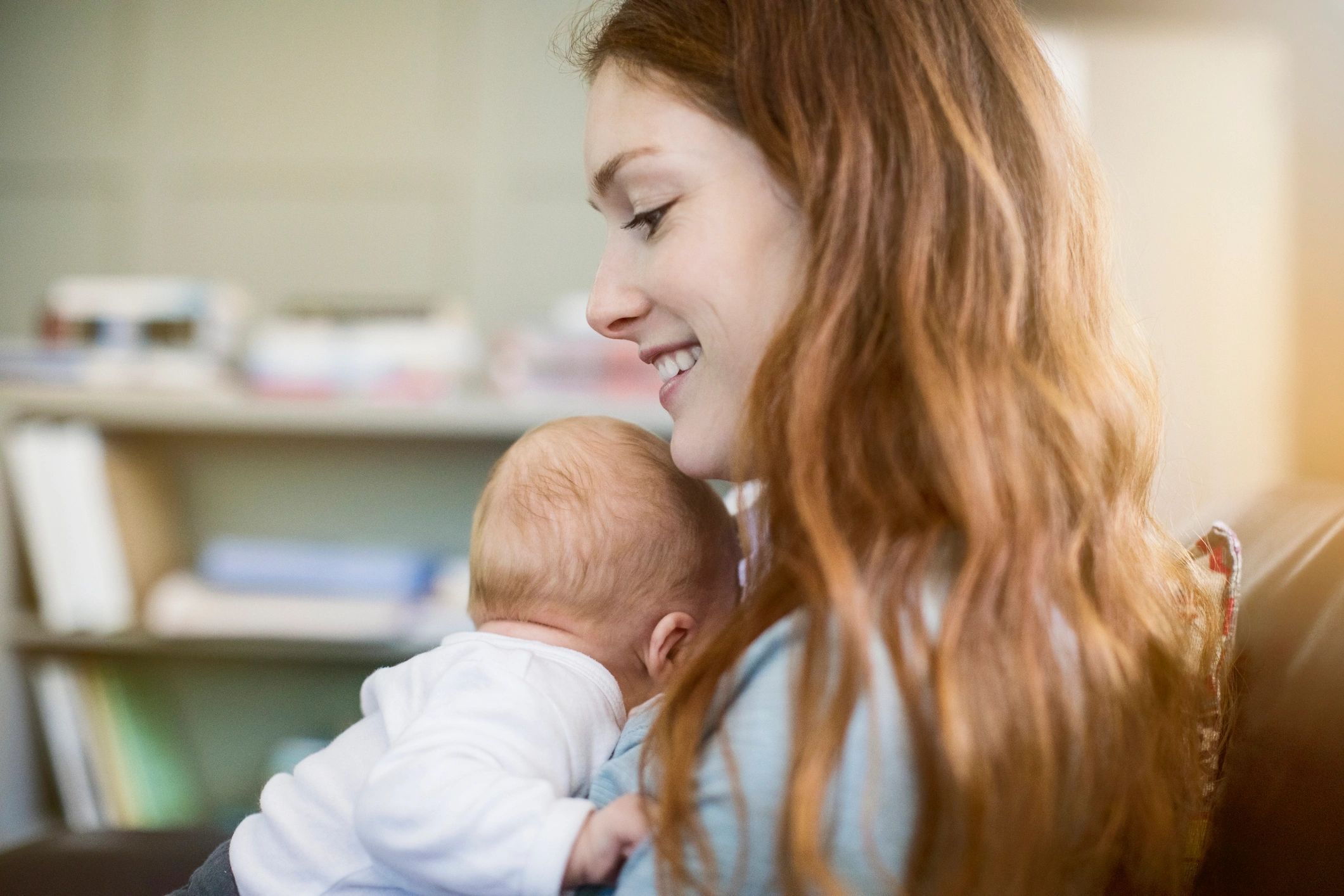 Mother holding newborn in a calm home environment